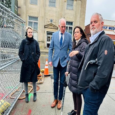 Four people standing outside next to a fence, Senator Bob Casey, Borough President, Mayor and Manage